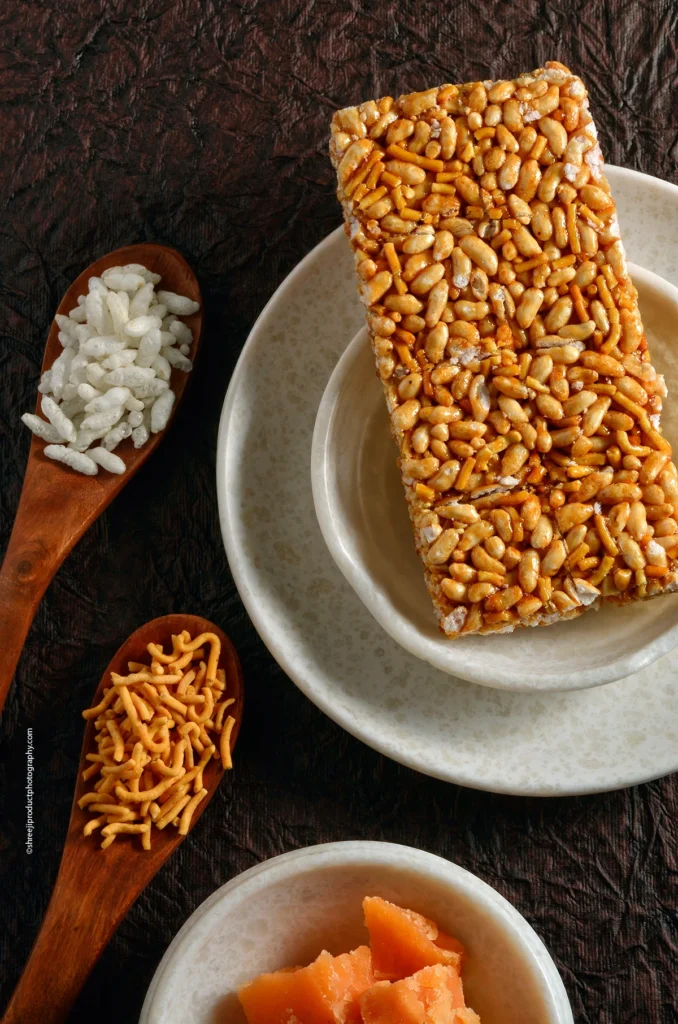 Sev Murmura Chikki in a white plate – product photography by Shreeji, Nagpur